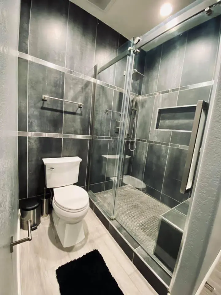 A toilet beside a shower